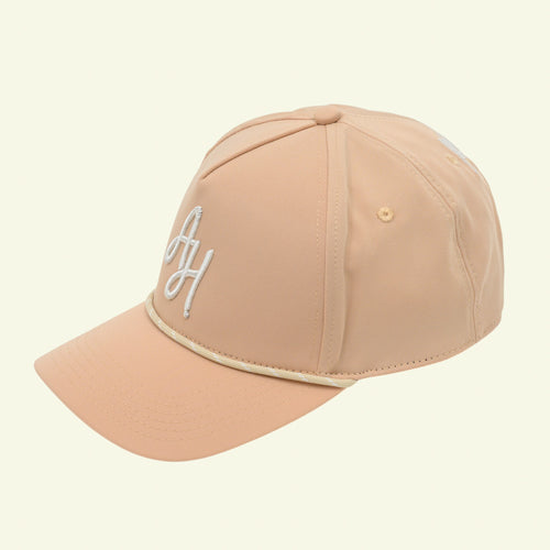 Load image 1 in gallery view. Tan rope golf cap, three-quarter view with white AH monogram and cream rope on the brim